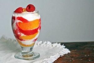 Recept online: Zmrzlinový pohár s broskvemi a malinovou omáčkou: Broskve a maliny s vanilkovou zmrzlinou v malinové omáčce
